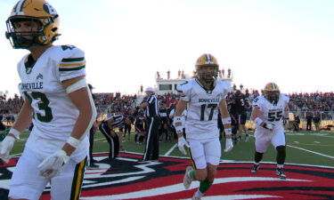 Bonneville and Hillcrest football players head back to their respective sidelines after a pre-game coin toss.