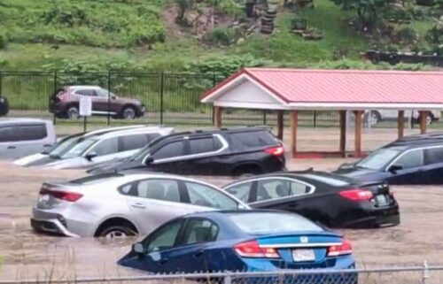 Cars are submerged in a parking lot of Westernport Elementary School as flooding forces the evacuation of the school